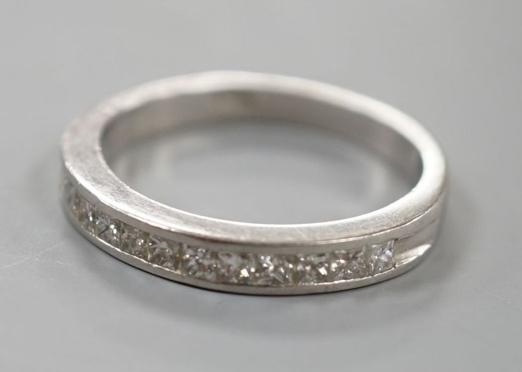 A platinum and twelve stone diamond set half eternity ring, size R, gross weight 6.4 grams.